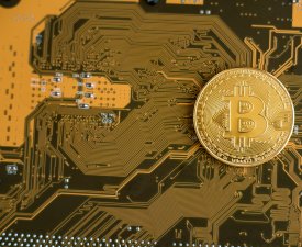 Bitcoin and motherboard. Crypto currency Gold Bitcoin, BTC, Bit Coin. Macro shot of Bitcoin Blockchain technology, bitcoin mining concept. Soft selective focus. Copy space