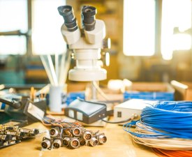 Large modern electron microscope and embedded microcircuits are stacked on test plate to prepare for the research of electronic components in a scientific laboratory