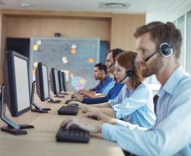 Side view of business people working at desk in call center